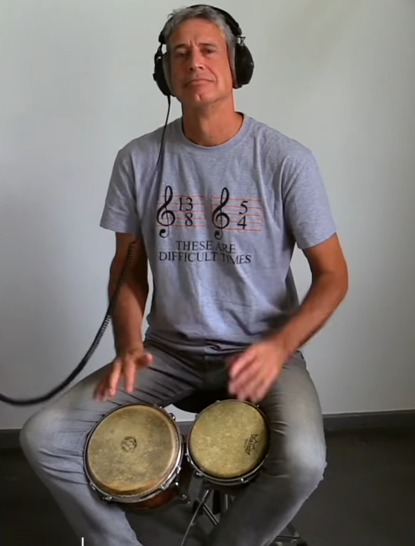 Michael playing bongos with headphones